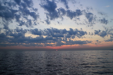 Fototapeta premium purple sunset dramatic seascape, sun drowned in the sea, panorama