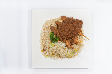 Chicken skewers served with a tasty peanut sauce and fried rice