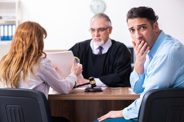 Young couple in the courthouse in divorce concept