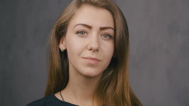 Portrait of an attractive girl close-up. Green eyes. Slow motion. 4k
