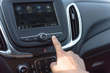 Naklejka premium Male hand press the Next button on modern car dashboard