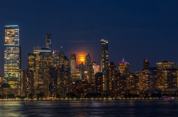 Full Moon Over Manhattan Skyline at night - obrazy, fototapety, plakaty