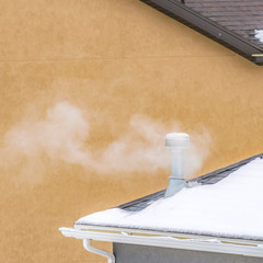 Close up view of the roof of a home covered with fresh white snow in winter