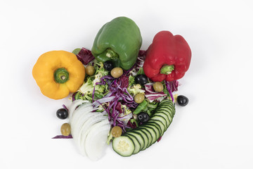 Top view of a nutritious and delicious tropical vegetable salad - Sliced cucumber, chopped red cabbage, olives, spinach and chopped onions