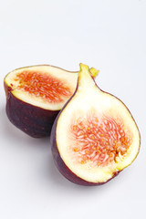 Ripe juicy figs on a white background.