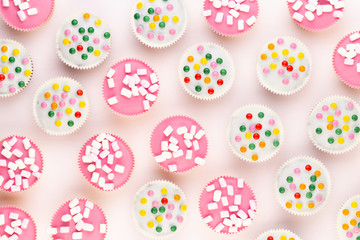 Colorful cupcakes on a white background.