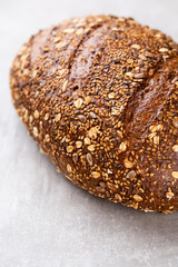 Gold rustic crusty loaves of bread and buns on wooden background. Still life captured from above top view, flat lay.