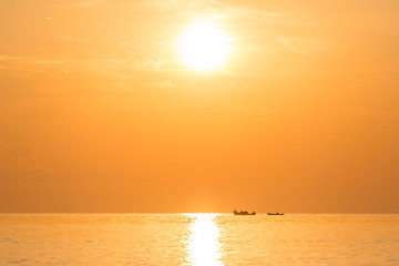 returning fishermen boat silhouette against orange sunrise on Lake Malawi, the sun glitter on the Lake, South-East-Africa