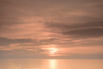 Fishermen boat silhouette against orange sunrise on Lake Malawi, the sun glitter on the Lake, South-East-Africa