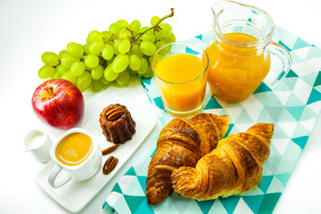 Continental breakfast with croissants, fruit and coffee