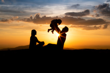 Fototapeta na wymiar mother, Father and daughter at sunset