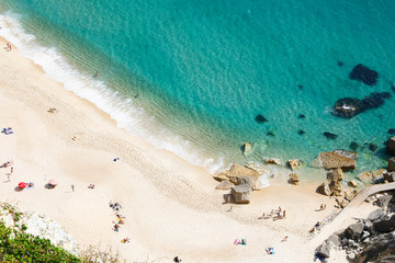 Nazare, Leiria, Portugal - July 01, 2019: Tourists enjoy Nazare Beach, from the viewpoint of Suberco, in the Leiria District, in Portugal.