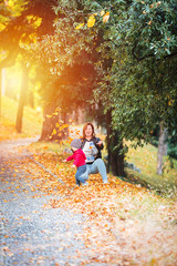 Two years old toddler have fun outdoor in autumn park