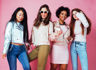 different nation girls with diversuty in skin, hair. Asian, scandinavian, african american cheerful emotional posing on pink background, woman day celebration, lifestyle people concept