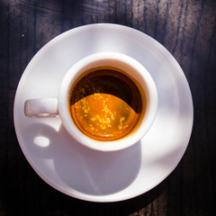 Cup of italian coffee  on the dark table