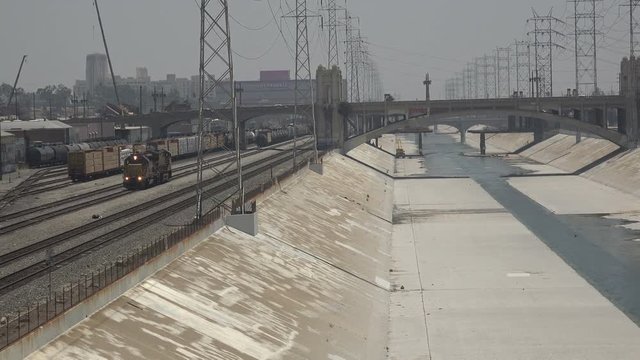Freight train approaching along the Los Angeles river in downtown LA