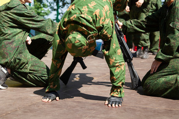 Military training. Training soldiers for military operations. Guys in uniform perform exercises. Military in active action.