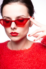  young woman in red sunglasses, red nails, red lipstick