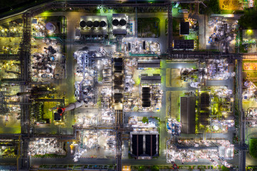 Aerial view oil refinery and gas refinery plant form industry zone at night.
