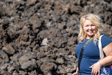 Woman hiker poses on the Trail to Lava Butte on the trail of Molten Lands in Newberry National...