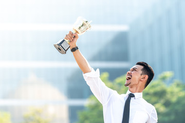Malay Businessman wins a trophy. Top employee concept