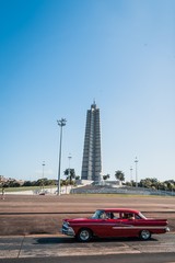 Revolution monument in La Havana Cuba with a red car