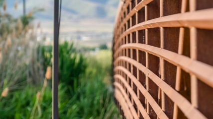 Fototapeta premium Close up of the brown metal lattice guardrail of a bridge on a sunny day