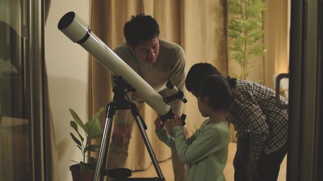 Father doing astronomical observation with children