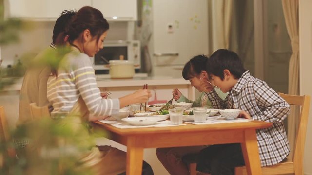Family of four eating dinner