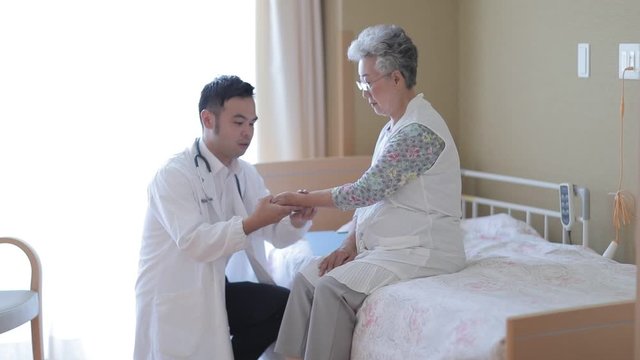 Doctor doing medical exam on senior patient in nursing home