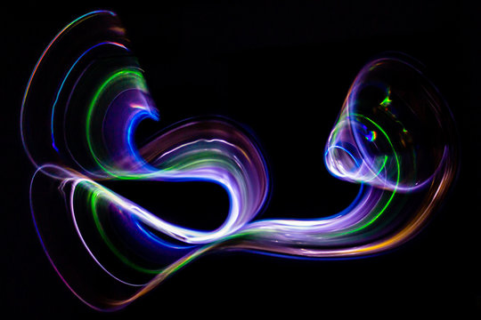 3d illustration. Abstract light painting on black background. Abstract art of iridescent grilling colors. Long exposure