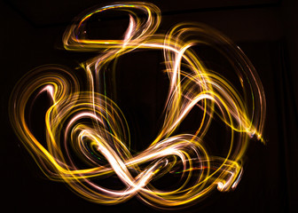 3d illustration. Abstract light painting on black background. Abstract art of iridescent grilling...