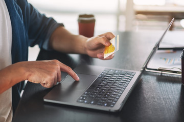 Businessman using laptop and credit card for shopping online