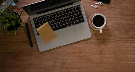 Rustic designer workplace with laptop and a cup of coffee