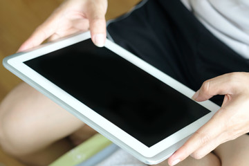 hands of people are using the tablet to find information and to entertain .Concept of technology