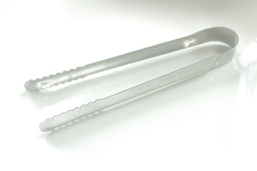 Ice cube tongs on white background 