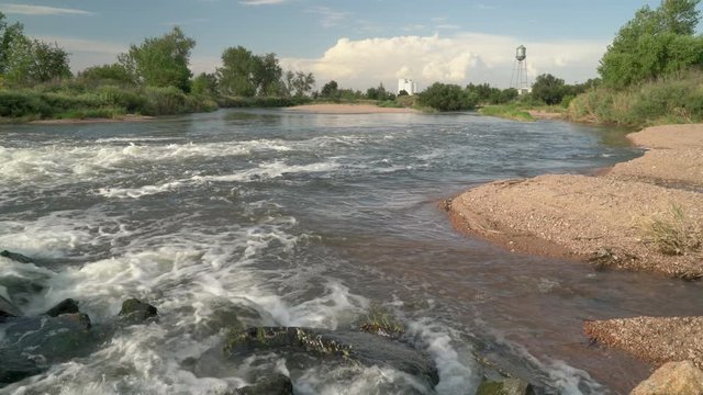 South Platte River at Brighton in northern Colorado, summer scenery below a dam.