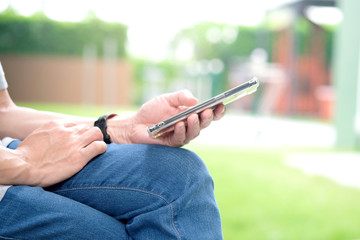 Men use smartphones and internet to get information. At the park on holiday