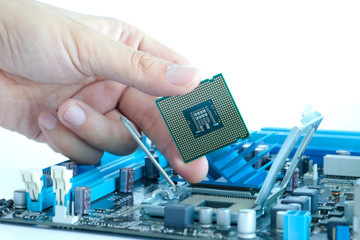 Hand of computer engineering brings computer cpu processor memory change components into socket processor for maintenance.Technology and development concept
