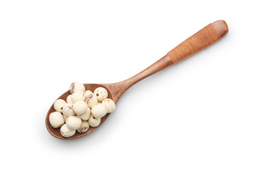 Dried lotus seeds in a wooden spoon isolated on white background. Top view.
