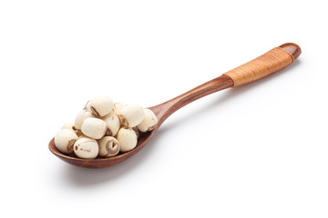 Dried lotus seeds in a wooden spoon isolated on white background