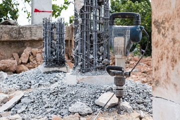 Jackhammer stand vertically at bridge construction site repair.