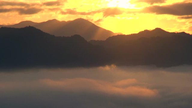 Timelapse&nbsp;of mountains in clouds at sunrise