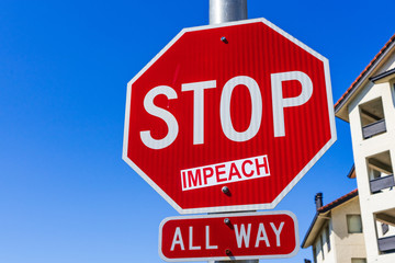 Impeach sticker applied on a Stop traffic sign; San Francisco bay area, California