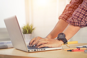 Fototapeta premium Close up Man working at home office hand on keyboard. vintage color.