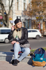 Lady girl happy smiles, sits skateboard.