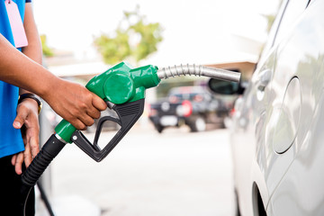 Man Refill and filling Oil Gas Fuel at station.Gas station - refueling. To fill the machine with fuel. Car fill with gasoline at a gas station. Gas station pump. 