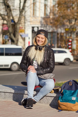 Lady girl happy smiles, sits skateboard.