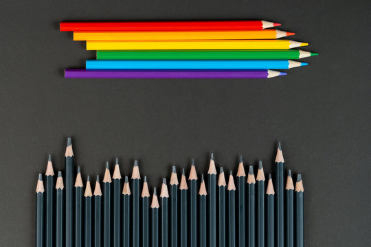 black and lgbt color pencils on black paper background. Mock up, copy space. Concept of integration lgbt community. Friendship and tolerance towards homosexual people.