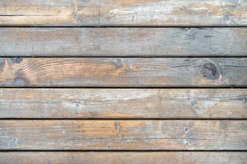 Obraz premium Old gray wooden panels. Granary board Peeled wood panels with gaps between them. Background.